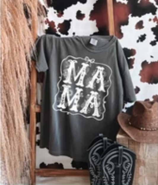 Gray t-shirt with 'MAMA' print on a wooden stand against a cowhide rug.